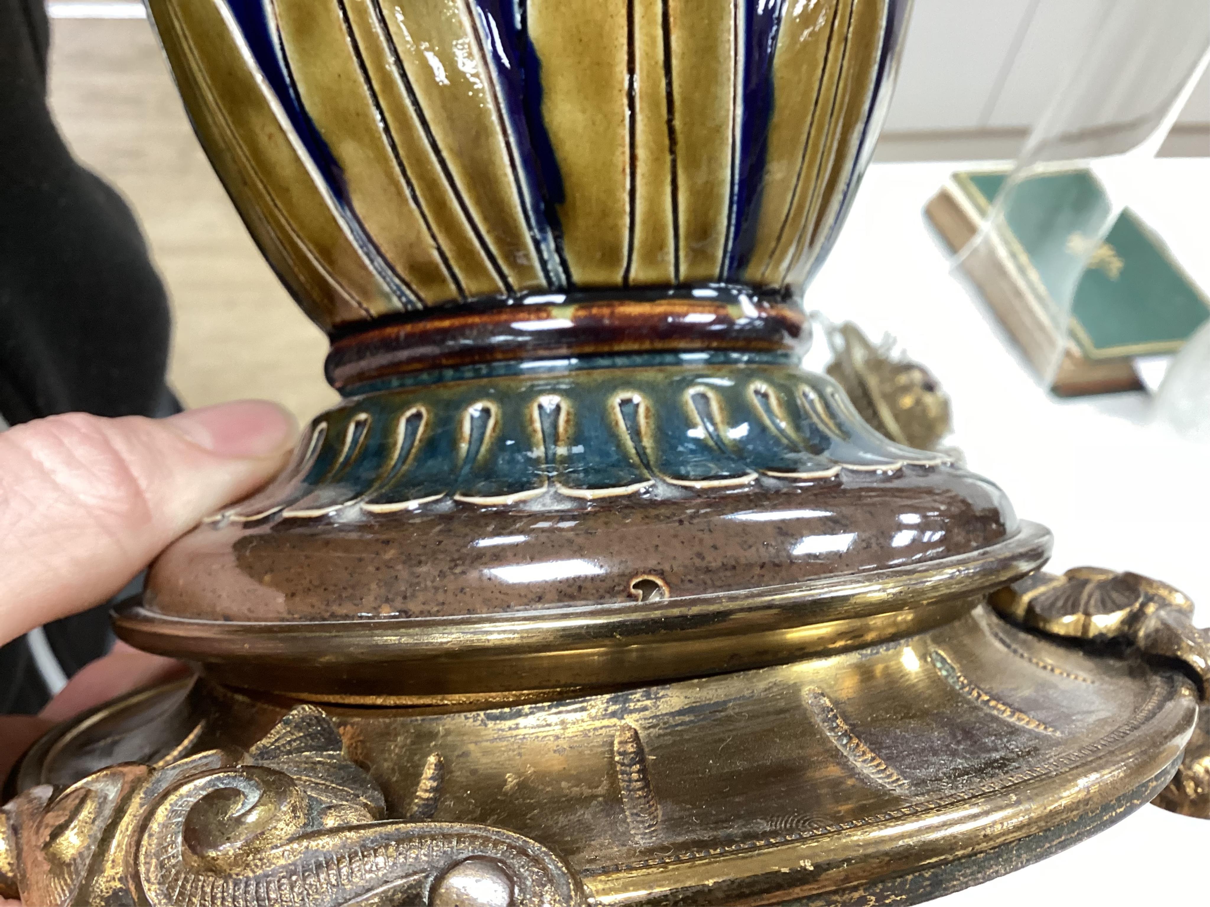 Florence Barlow for Doulton Lambeth, a stoneware oil lamp, pate-sur-pate decoration, dated 1883, the reservoir by another assistant, 47cm to top of burner. Condition - fair to good (some wear)